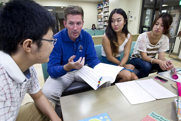 Four Rotary Peace Fellows study and discuss materials around a table.