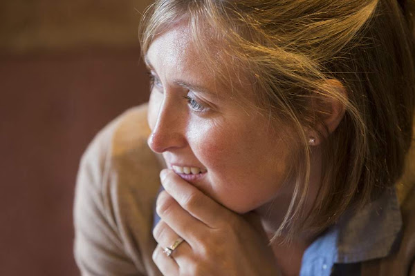 A participant listens and smiles at a Rotary gathering.