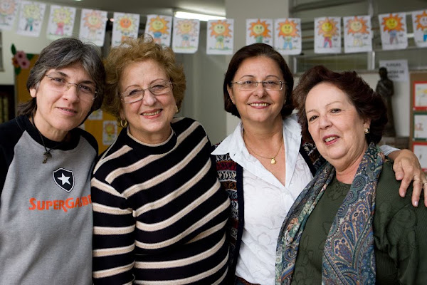 Four women smile together during a Rotary-supported school visit.